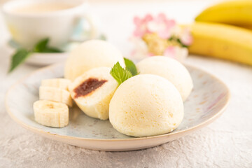 Japanese rice sweet buns mochi filled with jam on a gray concrete. side view, selective focus.