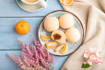 Japanese rice sweet buns mochi filled with tangerine jam on a blue wooden. top view.