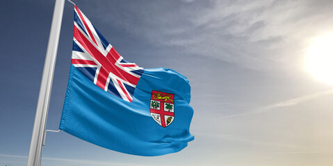 Fiji national flag cloth fabric waving on beautiful sky grey Background.