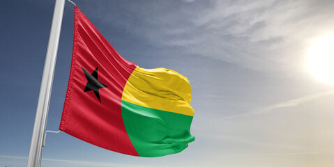 Guinea-Bissau national flag cloth fabric waving on beautiful sky grey Background.