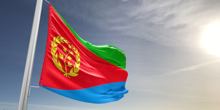 Eritrea national flag cloth fabric waving on beautiful sky grey Background.