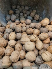 walnuts poured into a basket on the supermarket counter