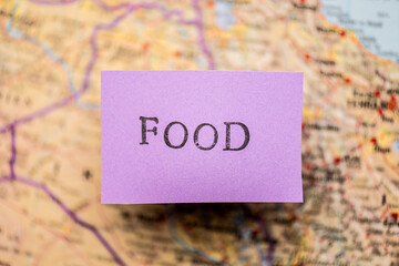 Food stencil text on purple paper over a map.