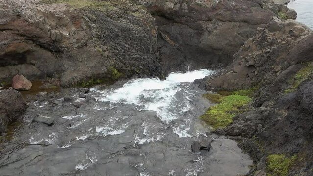 Fantastic landscape with flowing rivers and streams with rocks and grass in Iceland.