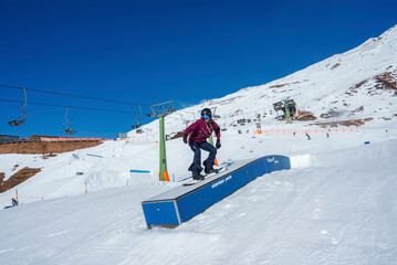 Tourist snowboarding on snow covered mountain during winter vacation, winter holiday travel concept