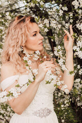 A beautiful bride near a cherry blossom. Spring Wedding