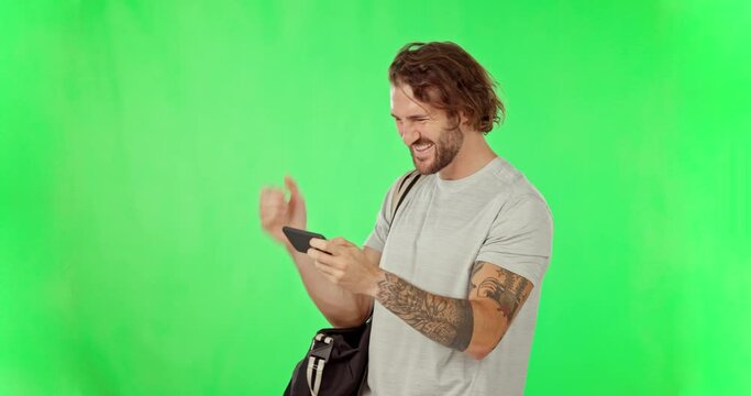 Fitness man, winner or phone to celebrate on green screen with fist and laughing for sports game competition. Excited male, smartphone and happy for training success or winning bonus, yes or progress