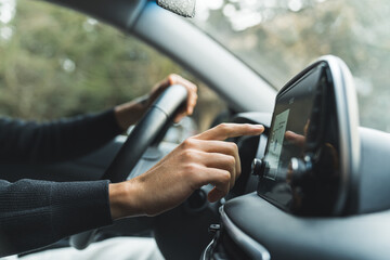 Closeup finger of a man car driver touching navigation screen . High quality photo