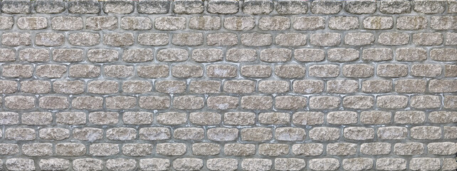 Modern grey brick wall in panoramic format.