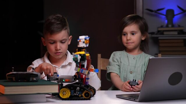 the boy and girl builds a robot and takes measurements with special equipment