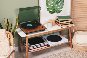 Stylish turntable with vinyl record on console table in cozy room - Powered by Adobe