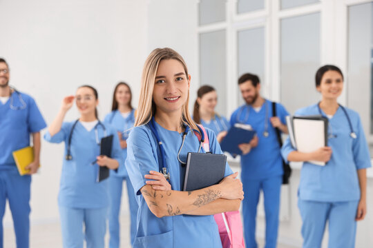 Young medical student with her classmates in university