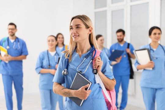Young medical student with her classmates in university