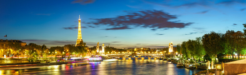 Seine river skyline view of Paris at sunset with Eiffel Tower in the background