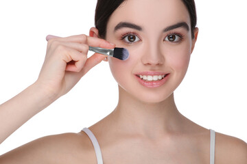 Teenage girl with makeup brush on white background