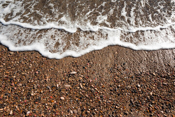 Fototapeta na wymiar Sea pebbles. Small stones gravel texture background.