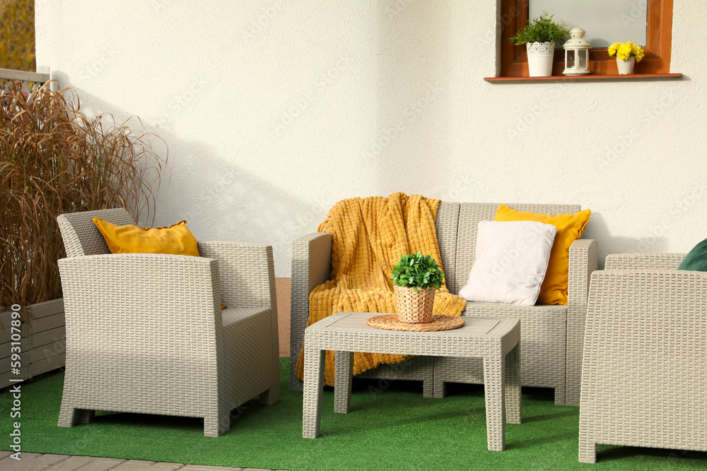 Canvas Prints Beautiful rattan garden furniture, soft pillows, blanket and houseplant outdoors