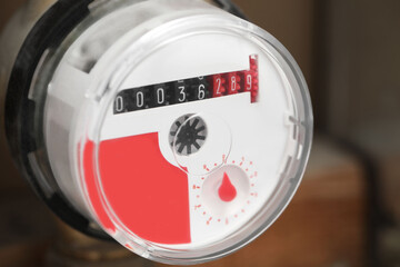 Closeup view of electric meter on blurred background, space for text. Water measuring device