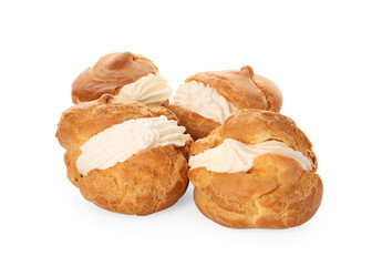Delicious profiteroles with cream filling on white background