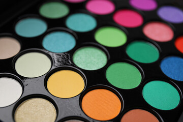 Beautiful eyeshadow palette as background, closeup. Professional cosmetic product
