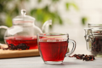 Delicious hibiscus tea on white wooden table