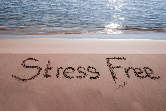 Stress Free Written On Sand Near The Sea At Beach