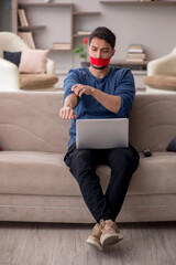 Mouth closed young man working from home