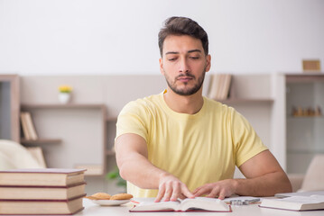 Fototapeta premium Young male student studying at home