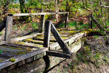 An image of a very old dilapidated wooden bridge which is too dangerous to walk on. 