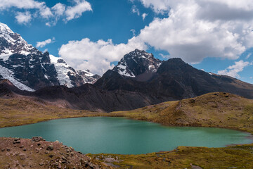Large hanging glaciers on the eastern face of Nevado Ausangate above permanent houses at 4900 m,...