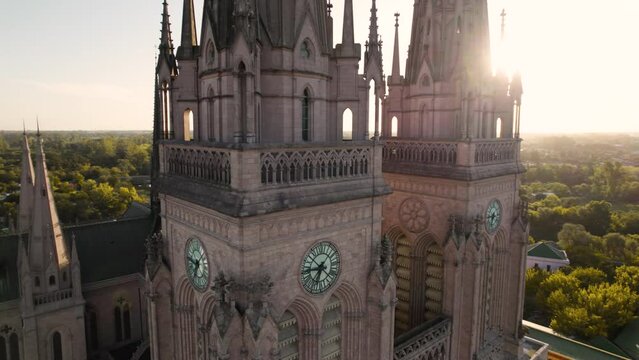 4k video of clock towers of ancient cathedral with sunset in the background, lujan, buenos aires, argentina