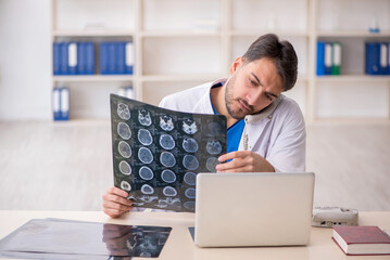 Young male doctor radiologist working in the clinic