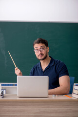 Young male teacher in telestudying concept