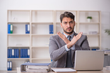 Young male employee working in the office