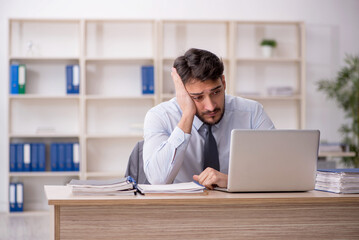 Young male employee working in the office