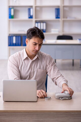 Young male employee working in the office