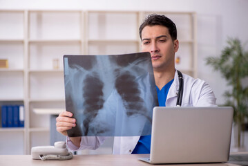 Young male doctor radiologist sitting in the clinic