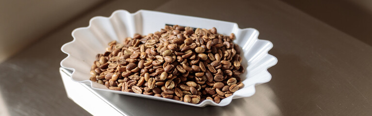 Electronic scales with white bowl of coffee beans