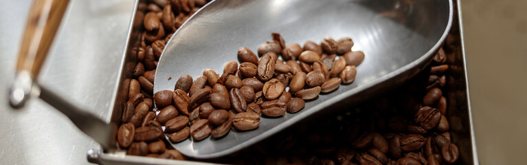 Container and scoop with roasted coffee beans