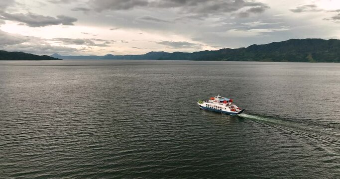 Aerial view of ferry on Lake Toba among the mountains. Sumatra, Indonesia.
