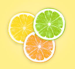 Colorful citrus lemon slices isolated on yellow background, top view
