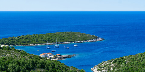 Obraz premium An island in the adriatic sea. Green island in blue adriatic sea , Dalmatia, Croatia. Travel destination, paradise, Travel concept