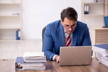 Young male employee working in the office