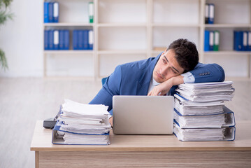 Fototapeta premium Young male employee working in the office