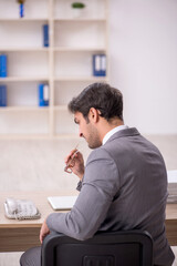 Young male employee working in the office