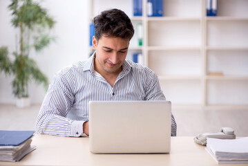 Young male employee working in the office