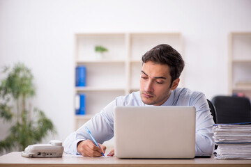 Young male employee working in the office