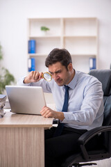 Young male employee working in the office