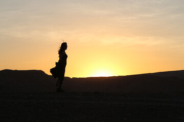 silhouette of a girl in the desert