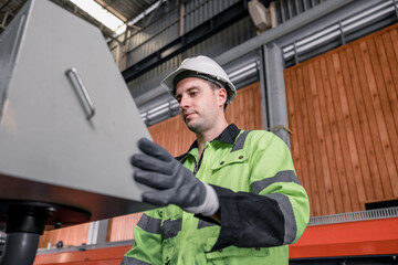 Experienced sheet metal workers use a computerized metalworking control panel display to create and regulate heavy gear. Automating and streamlining the placement of roofing modules for installation.